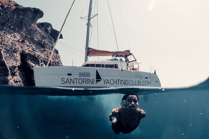 Beautiful Day Catamaran Caldera Cruise incl. Meal & Drinks - Sailing from Ammoudi toward the Volcano