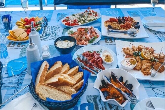 Half-Day Exclusive Catamaran Cruise in Santorini with Meal and Open Bar - Sailing below Fira and the Black Mountain