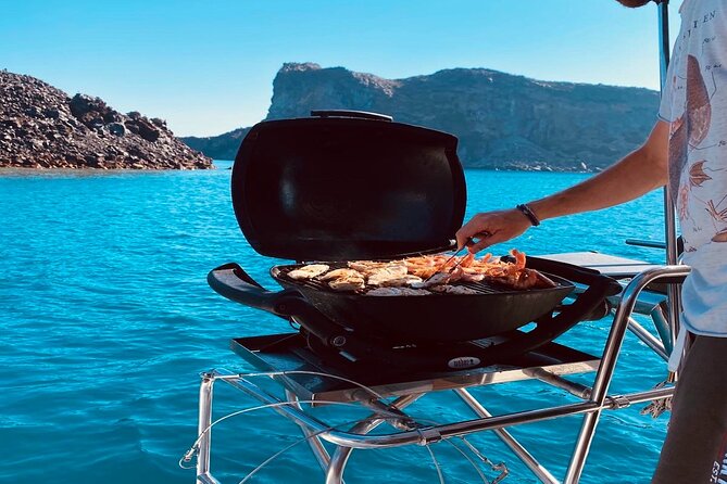 Half-Day Exclusive Catamaran Cruise in Santorini with Meal and Open Bar - Swimming near the volcano and hot springs