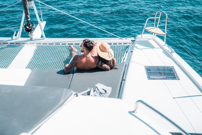 Majestic Catamaran Caldera Cruise with Snacks, Meal & Drinks - Passing Red Beach without the crowds