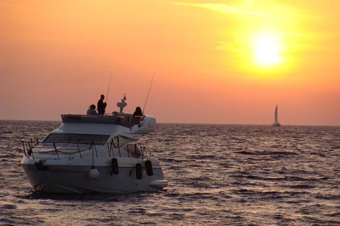 Private Motor Yacht Cruise with BBQ, Open Bar & Transfers - The Venetian Lighthouse and caldera cliffs