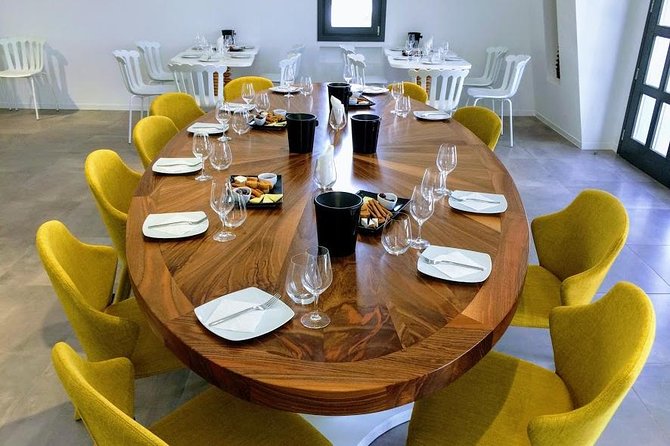 Private Santorini History and Wine Tasting 5-Hour Tour - Artemis Karamolegos adds a modern finish