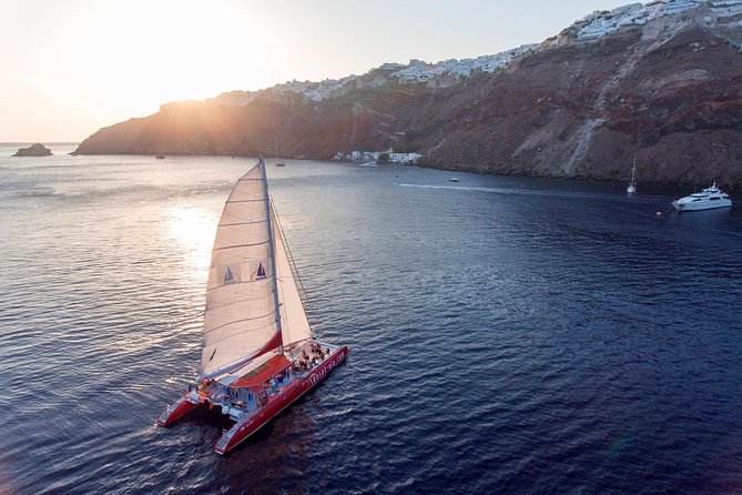 Sailing Catamaran Cruise in Santorini with BBQ, Drinks and Transfer - Red Beach from the water