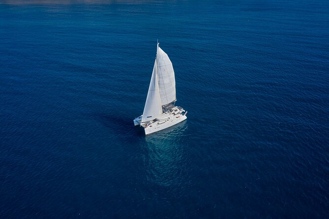 Santorini: Caldera Private Catamaran Cruise with Meal & Drinks - The lighthouse marks Santorini’s southern edge