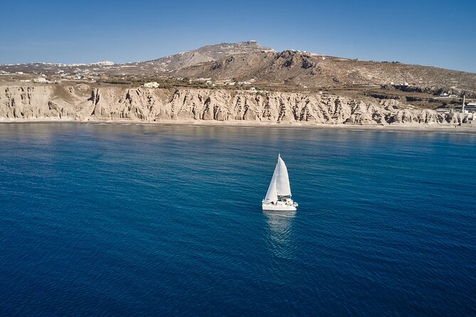 Santorini: Caldera Private Catamaran Cruise with Meal & Drinks - White Beach changes the color palette