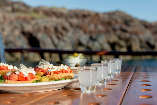 Santorini Caldera Sunset Traditional Cruise with Meal and Drinks - Mesa Pigadia, White Beach, and the Akrotiri coast