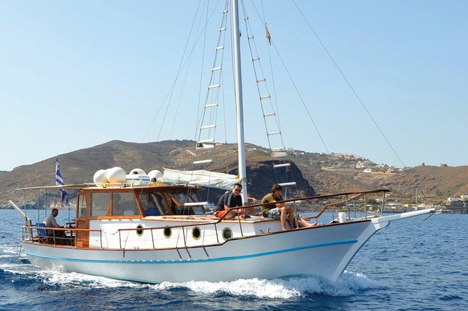Santorini Caldera Sunset Traditional Cruise with Meal and Drinks - Red Beach adds Santorini’s famous color