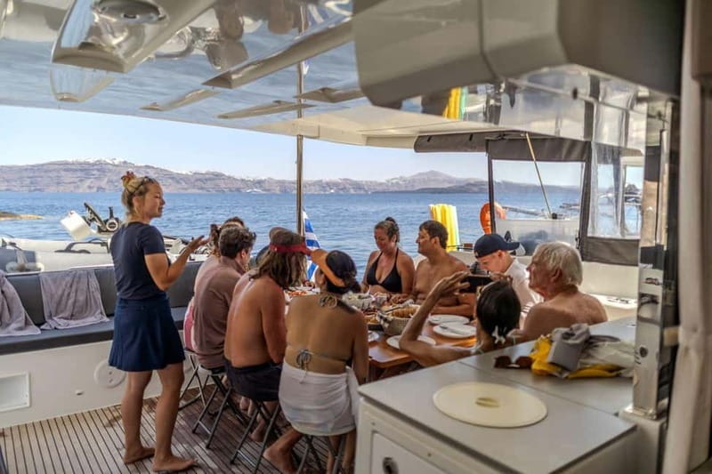 Santorini: Catamaran Cruise with Fresh Meal & Open Bar - Akrotiri Lighthouse and the caldera cliffs