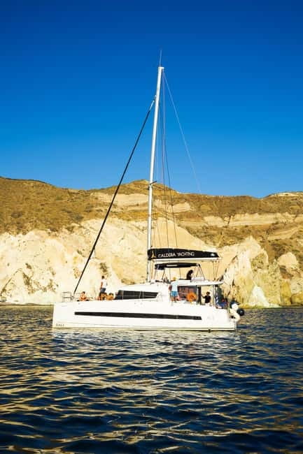 Santorini: Catamaran Cruise with Fresh Meal & Open Bar - Sunset sailing versus the daytime departure