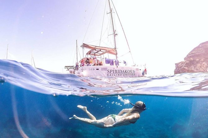 Santorini Classic Catamaran Cruise with BBQ, Drinks and Transfers - Indian Rocks, caves, and the volcanic coast