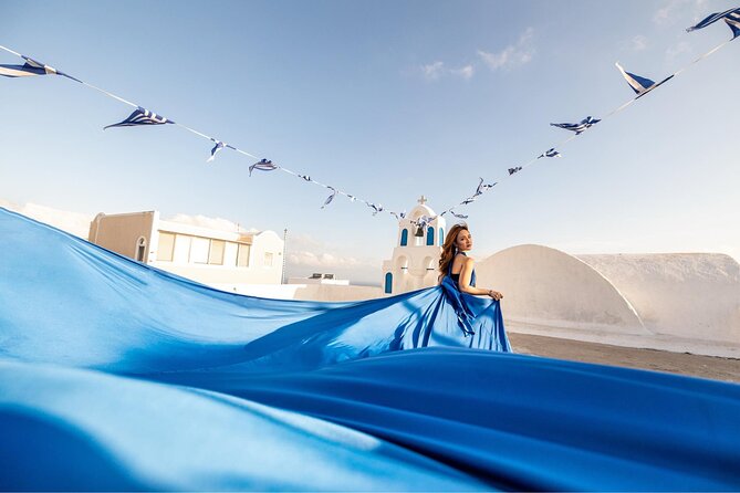 Santorini: Flying Dress Professional Photography <em>Dress Included</em> – Oia’s White Walls Become Your Studio’ /></p>
<p><p>This is not a standard sightseeing walk with a few snapshots along the way. The focus is you, the dress, and the way the fabric moves against Santorini’s famous white buildings, blue details, steps, and sea views.</p>
</p>
<p><p>The photo team works around the village rather than keeping you in one single viewpoint. That gives your final gallery more variety. One image might show the dress sweeping along a white lane, while another uses a wider view of the caldera or a different village backdrop.</p>
</p>
<p><p>The one-hour shoot centers on Oia. That is the simplest choice if you have limited time, want a shorter session, or care most about the classic Santorini look. Pickup and drop-off are not included with this option, so you meet at the bus station in Oia and return there when finished.</p>
</p>
<p><p>The three-hour photo tour gives the team more time to move between villages. It includes transport, up to three villages, and six to twelve photo locations, depending on the option you select. That variety is useful for couples, friends, and families who want more than one visual setting.</p>
</p>
<p><p>You should understand the tradeoff. More locations mean more time in a vehicle and more walking between viewpoints. The reward is a broader set of photographs, but this is not a quiet, sit-down portrait session.</p>
</p>
<h2>Choosing the Dress Before You Arrive</h2>
<p>Dress Included</em> – Choosing the Dress Before You Arrive’ /></p>
<p><p>After booking, you choose a flying dress through email. The available information says you can select size and color in advance, which removes one major uncertainty on the day.</p>
</p>
<p><p>The outfit is included for solo and couple bookings, with one dress total. In the Best Friends option, each woman receives a dress. Men’s clothing is not included, so male participants should plan their own outfit.</p>
</p>
<p><p>Do not expect a full styling package. Makeup, hairdressing, jewelry, and retouched edits are extra or unavailable within the stated package. The included photographs are professionally edited, but they do not include special alterations such as slimming or skin smoothing.</p>
</p>
<p><p>That distinction matters. You are paying for photography and standard editing, not a complete fashion makeover. Arrive ready for the camera if you want a polished result, since makeup and hair services are not part of the experience.</p>
</p>
<p><p>The dress itself changes how you move. You will likely need help arranging the fabric before each shot, and the assistant can help with the practical side of that. Wear comfortable shoes for the walking portions, then remove them when the framing allows. Bare feet often keep the picture clean, and your practical shoes do not need to appear in the final image.</p>
</p>
<div class="twil" style="margin: 20px 0; padding: 15px 0;"><p>More Flying Dress Photoshoots in Santorini:</p><ul style="margin: 10px 0; padding-left: 0; list-style: none;"><li style="margin: 0 0 12px 0; padding: 0 0 12px 0; border-bottom: 1px solid #F6DFE8; line-height: 1.4;"><a href="https://santorinitourreviews.com/santorini-2h-private-flying-dress-photoshoot-with-transportation/">Santorini 2h Private Flying Dress Photoshoot with Transportation</a><br><span style="font-size: 0.82em; color: #555;"><span style="color: #C2185B;">★</span> 5.0 &nbsp;&middot;&nbsp; 357 reviews</span></li><li style="margin: 0 0 12px 0; padding: 0 0 12px 0; border-bottom: 1px solid #F6DFE8; line-height: 1.4;"><a href="https://santorinitourreviews.com/exclusive-santorini-flying-dress-photoshoot-with-pickup/">Exclusive Santorini Flying Dress Photoshoot with Pickup</a><br><span style="font-size: 0.82em; color: #555;"><span style="color: #C2185B;">★</span> 4.5 &nbsp;&middot;&nbsp; 336 reviews</span></li><li style="margin: 0; padding: 0; border-bottom: none; line-height: 1.4;"><a href="https://santorinitourreviews.com/flying-dress-photoshoot-in-santorini-by-flying-dress-photo/">Flying Dress Photoshoot in Santorini by Flying Dress Photo ©</a><br><span style="font-size: 0.82em; color: #555;"><span style="color: #C2185B;">★</span> 5.0 &nbsp;&middot;&nbsp; 137 reviews</span></li></ul></div><h2>What Happens During the Three Hours</h2>
<p><img width="669" height="446" decoding="async" src=