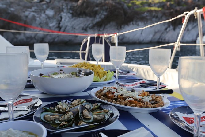 Santorini Half Day Catamaran Private Cruise incl. Meal, Drinks & Free Transport - The lighthouse and Aspronisi