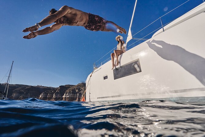 Santorini Oia: Luxury Sunset Cruise with Fresh Fish BBQ & Drinks - Mesa Pigadia, a black-beach swim