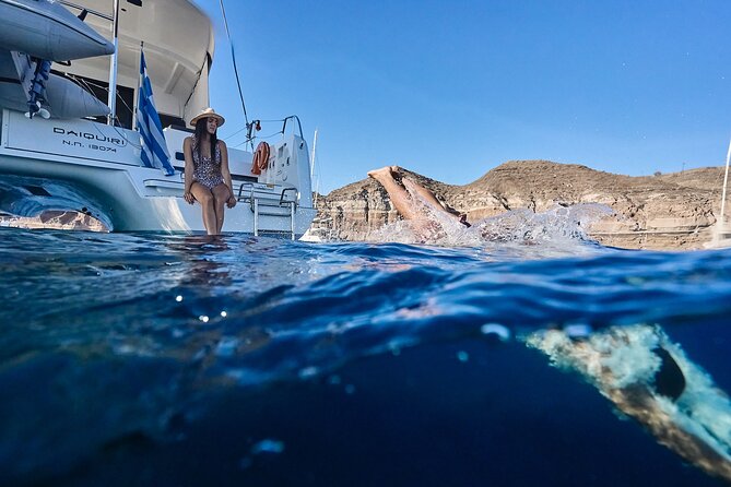 Santorini Oia: Luxury Sunset Cruise with Fresh Fish BBQ & Drinks - Red Beach and the onboard Greek BBQ