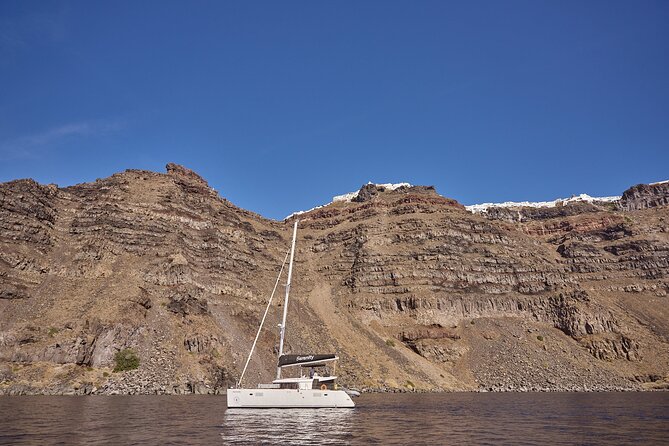 Santorini Oia: Luxury Sunset Cruise with Fresh Fish BBQ & Drinks - Drinks, music, and the feel onboard
