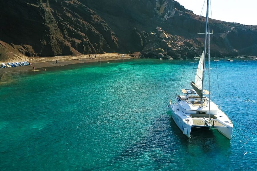 Santorini: Private Catamaran Tour with BBQ Meal and Drinks - A second volcano swim and the view toward Thirasia