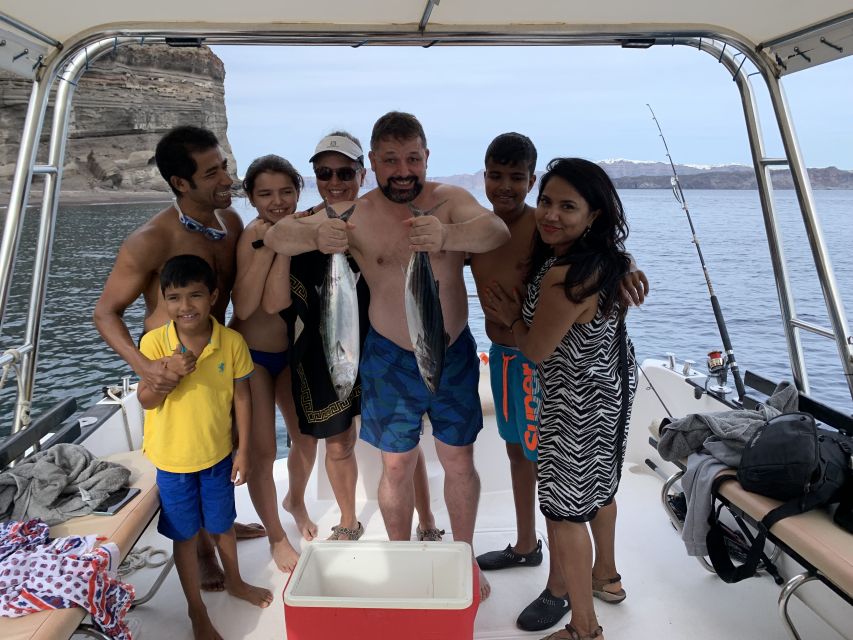Santorini Private Cruise boat fishing tour - BBQ, Snorkeling - Seeing Oia from the water at sunset