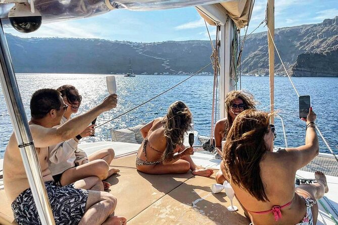 Santorini Sunset Sailing Cruise: Dinner, BBQ, Open Bar, Transfers - Red Beach gives you the first swim