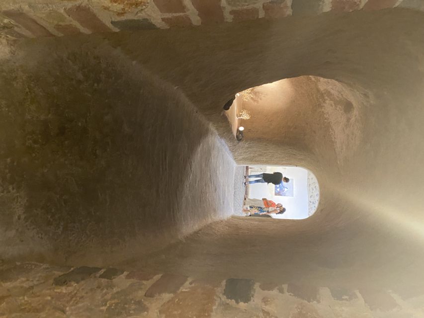 Santorini: Wine Tasting and Cave Settlement Tour - Walking through the traditional cave settlement