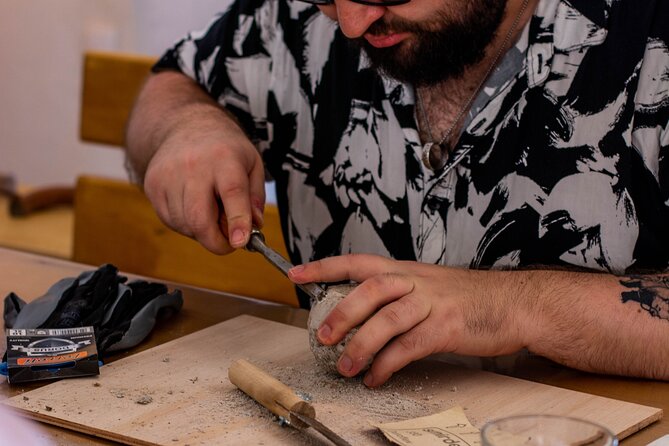 Wine tasting and Carving lesson in Santorini - Carving volcanic stone, one careful stroke at a time